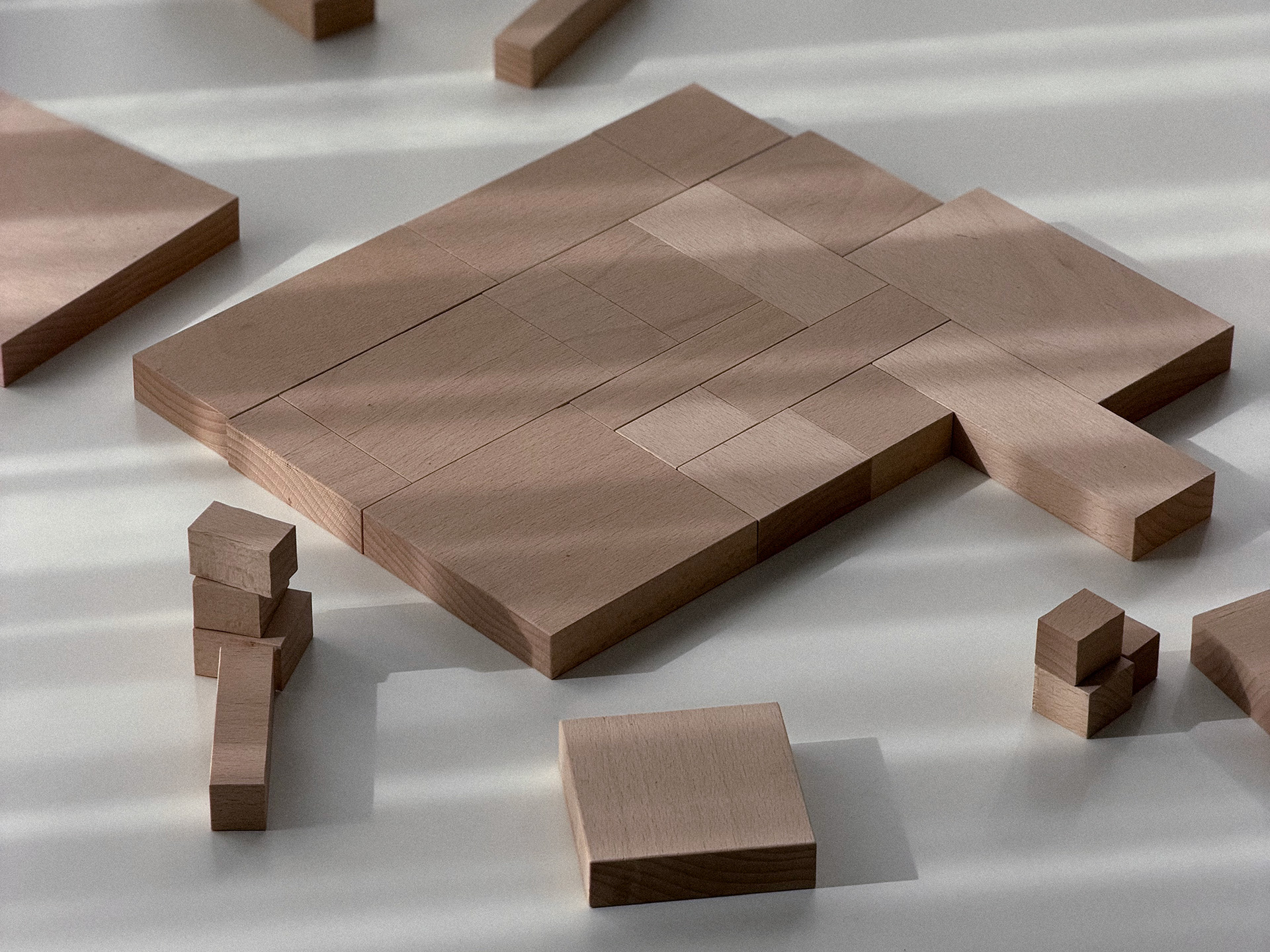 Wooden shapes arranged as an open composition on a tabletop.